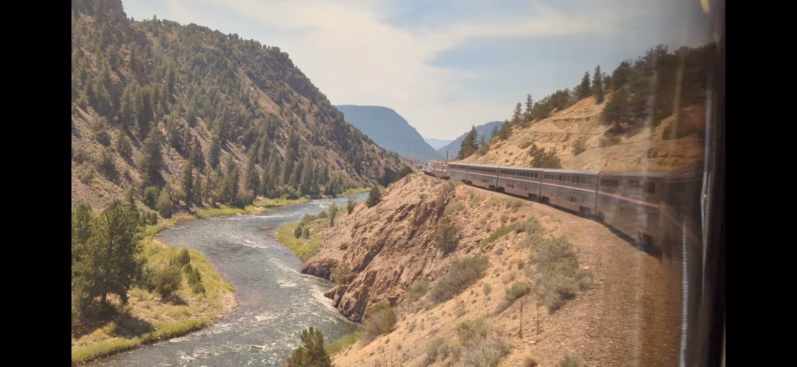 Amtrak train tracks running along the Colorado River canyon