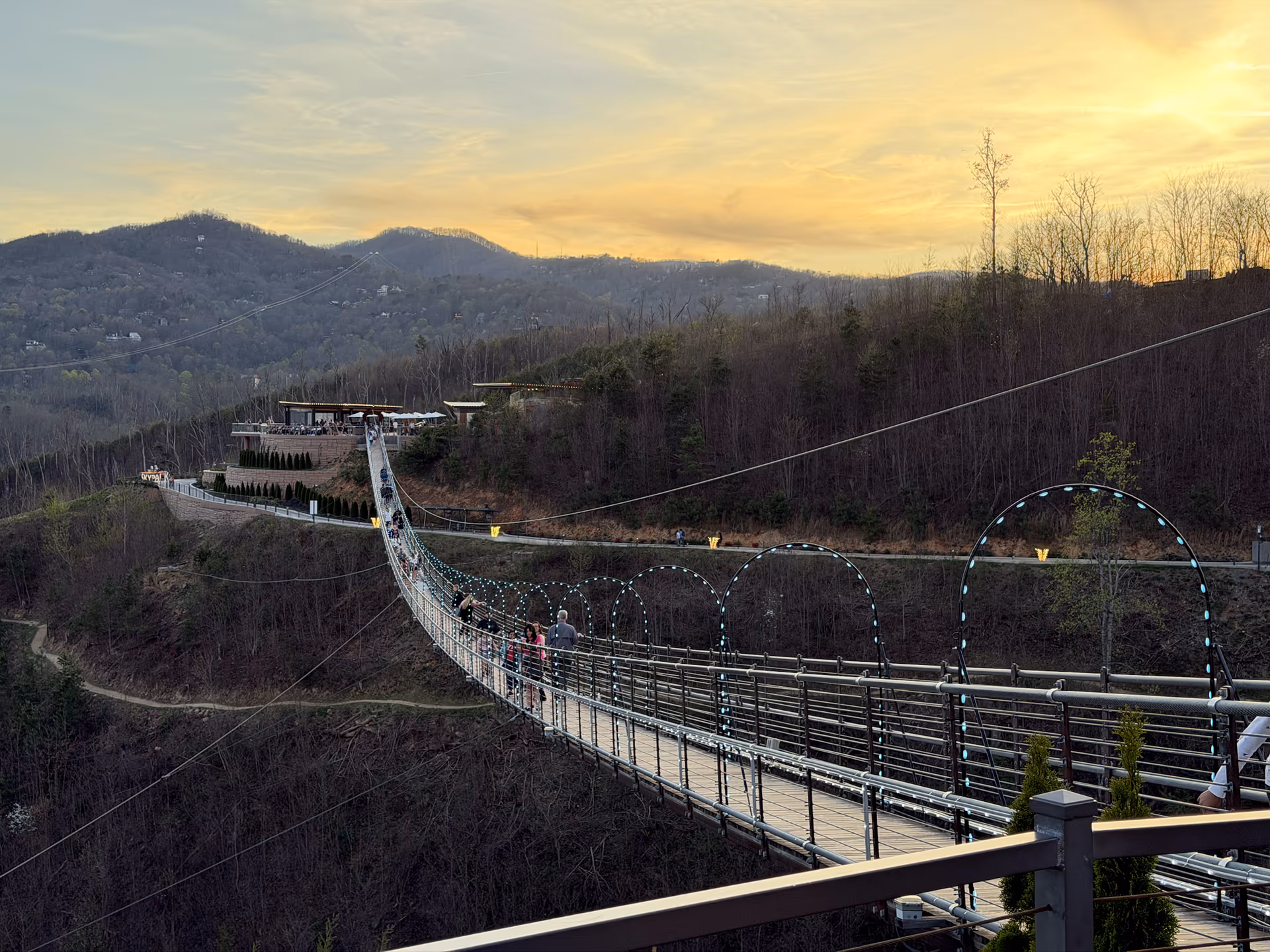 The Gatlinburg SkyPark bridge at evening with mountains behind it