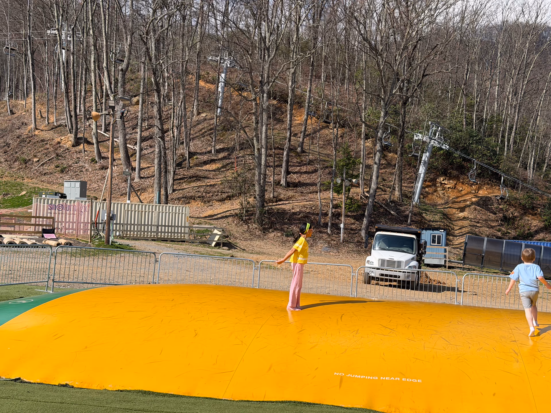 Jump pillow activity area at Ober Mountain with mountains behind it